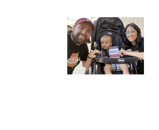 Two Arizona voters with a baby holding Adrian Fontes lit.